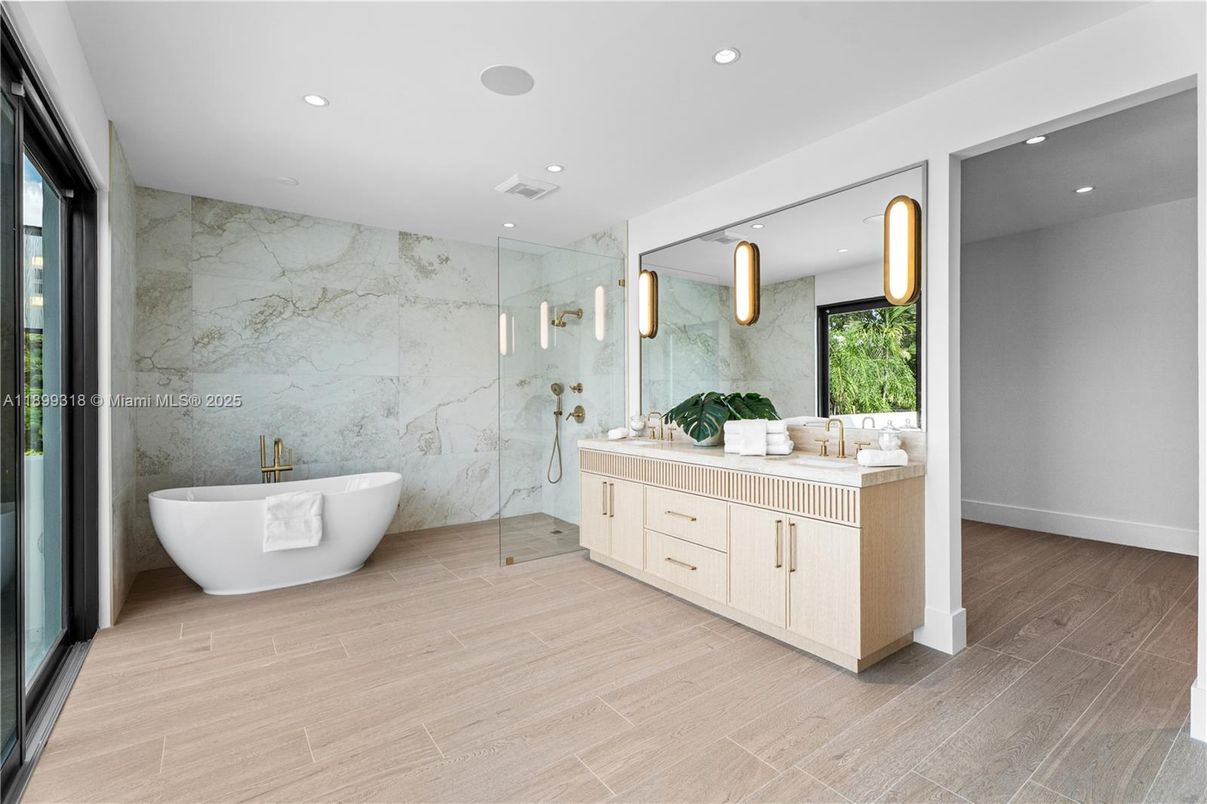 Bathroom, Dual Sink Vanities, Free Standing Baths, Glass Shower, Interior, Marble Walls, Recessed Lighting, Wood Texture Flooring