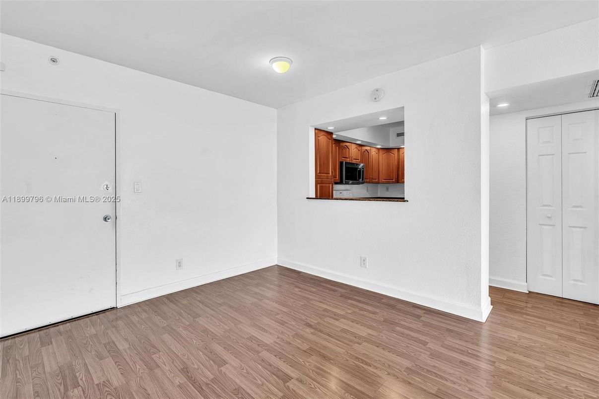 Empty room, Interior, Kitchen, Recessed Lighting, Stainless Steel Appliances, Wood Texture Flooring