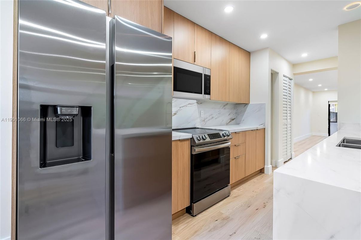 Interior, Kitchen, Marble Walls, Recessed Lighting, Stainless Steel Appliances, Wood Texture Flooring