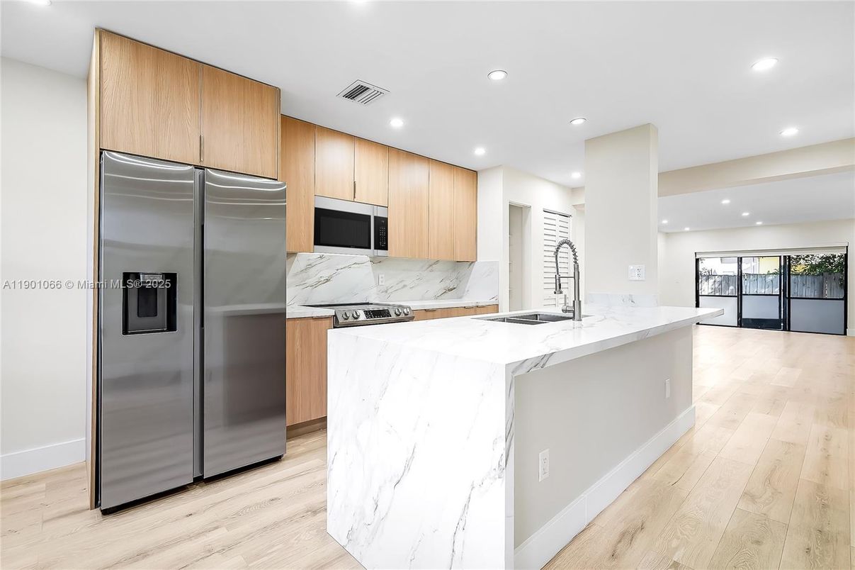 Interior, Kitchen, Marble Walls, Recessed Lighting, Stainless Steel Appliances, Wood Texture Flooring