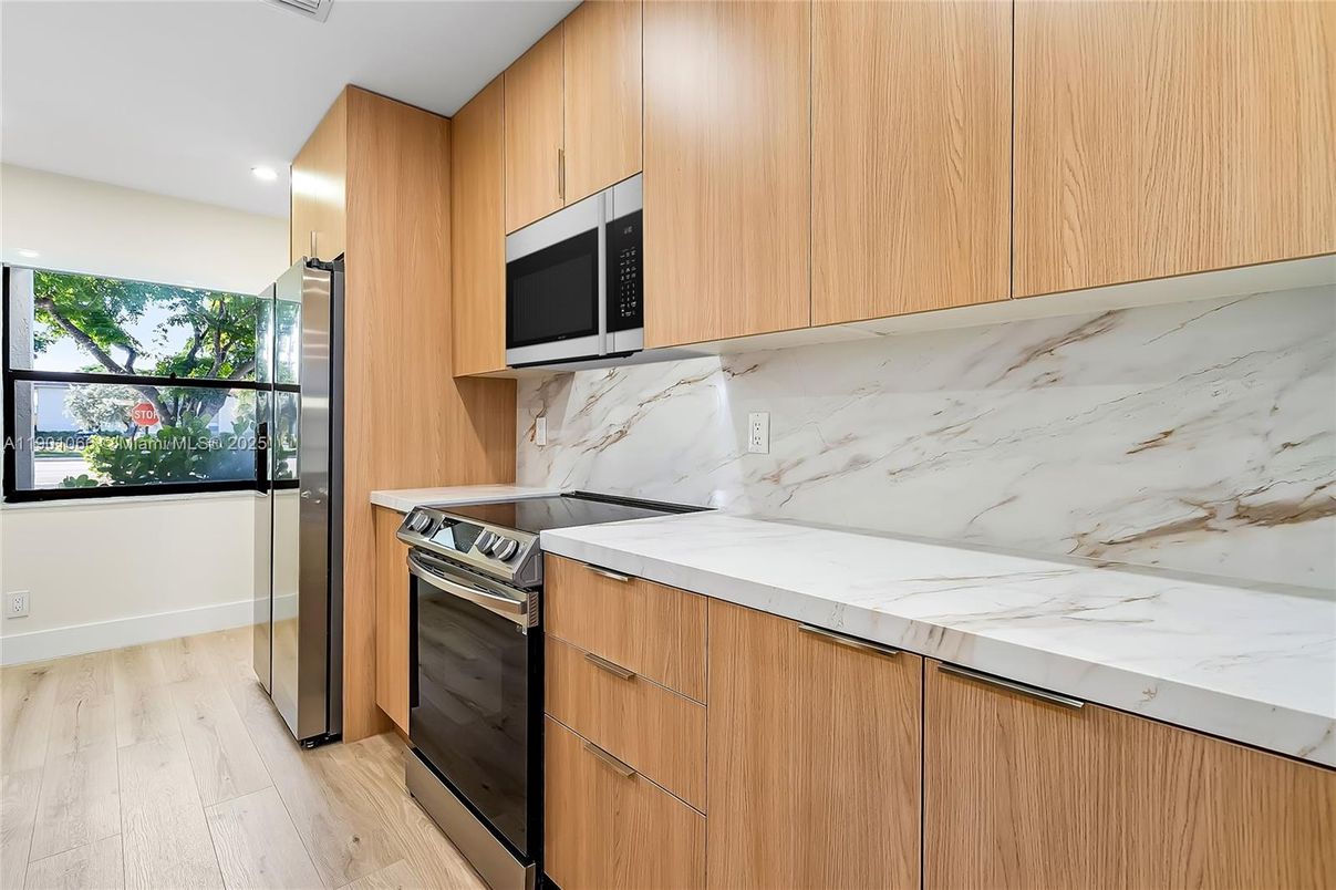 Interior, Kitchen, Marble Walls, Recessed Lighting, Stainless Steel Appliances, Wood Texture Flooring