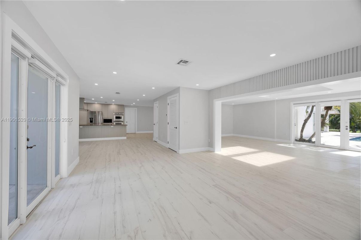 Empty room, Interior, Kitchen, Recessed Lighting, Stainless Steel Appliances, Wood Texture Flooring