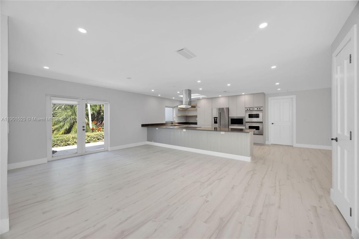 Empty room, Interior, Kitchen, Marble, Recessed Lighting, Stainless Steel Appliances, Wood Texture Flooring