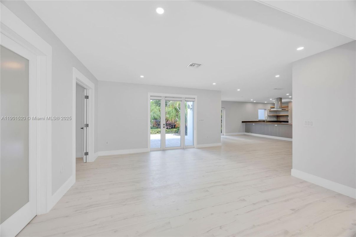 Empty room, Interior, Kitchen, Recessed Lighting, Stainless Steel Appliances, Wood Texture Flooring