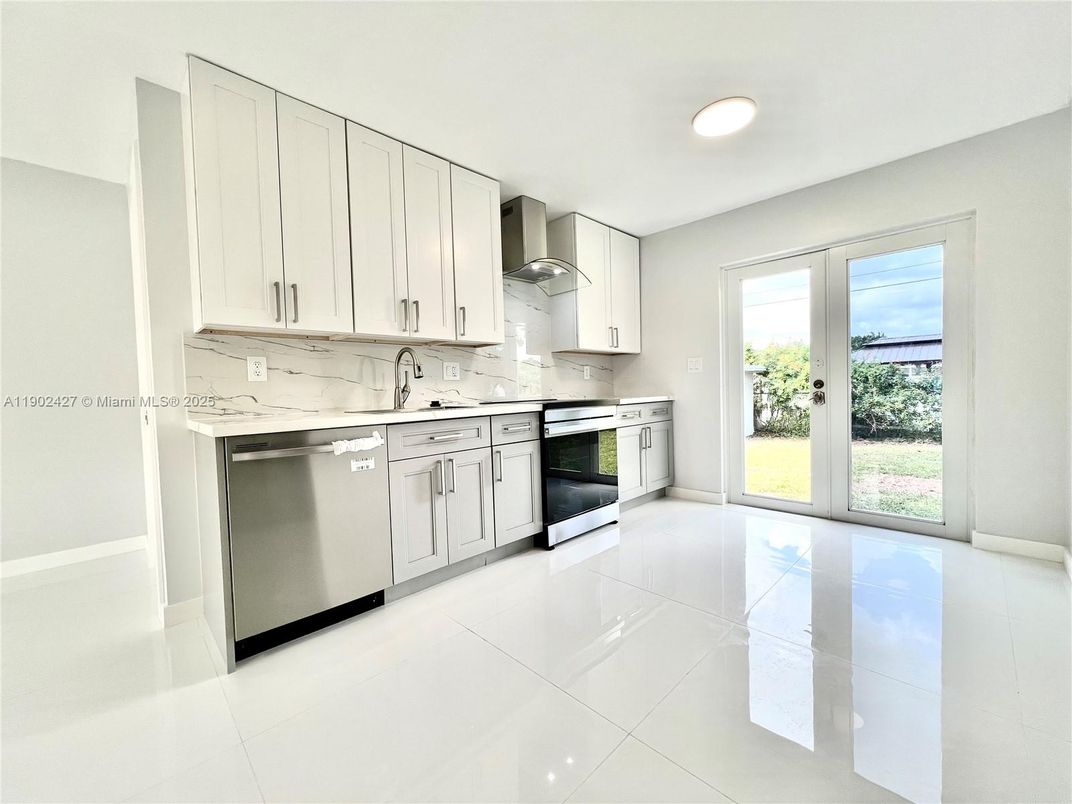 Interior, Kitchen, Marble Walls, Recessed Lighting, Stainless Steel Appliances