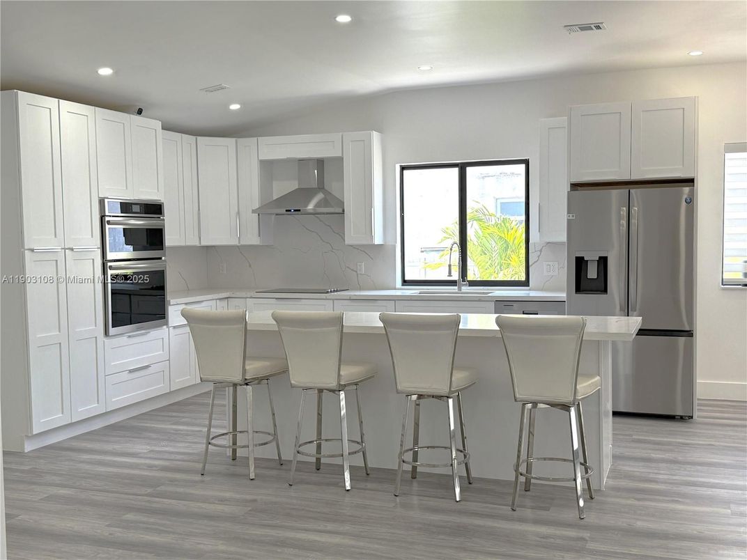 Interior, Kitchen, Marble Walls, Recessed Lighting, Stainless Steel Appliances, Wood Texture Flooring