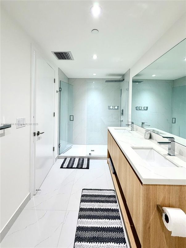 Bathroom, Dual Sink Vanities, Glass Shower, Interior, Marble, Marble Walls, Recessed Lighting