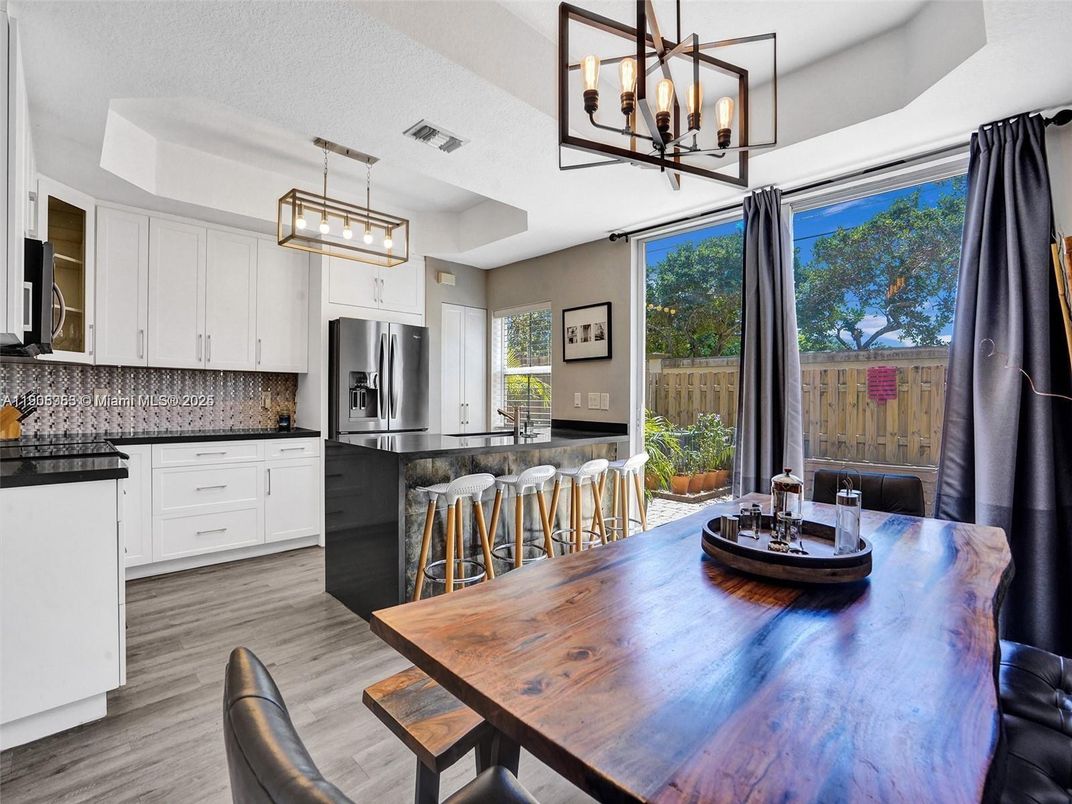 Chandelier, Dining room, Interior, Kitchen, Pendant Lights, Stainless Steel Appliances, Wood Texture Flooring