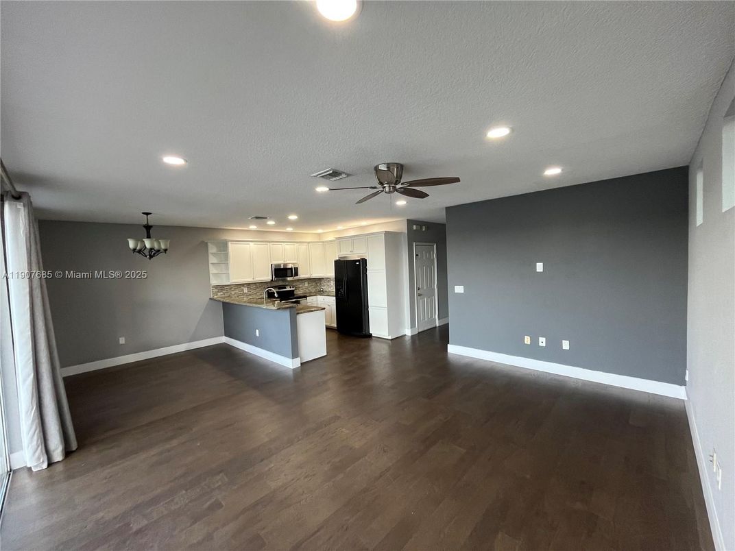 Chandelier, Empty room, Interior, Kitchen, Recessed Lighting, Stainless Steel Appliances, Wood Texture Flooring