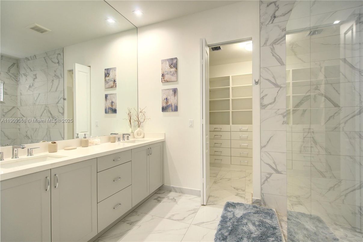 Bathroom, Dual Sink Vanities, Glass Shower, Interior, Marble, Marble Walls, Recessed Lighting, Walk-in Closets