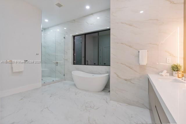 Bathroom, Dual Sink Vanities, Free Standing Baths, Glass Shower, Interior, Marble, Marble Walls, Recessed Lighting