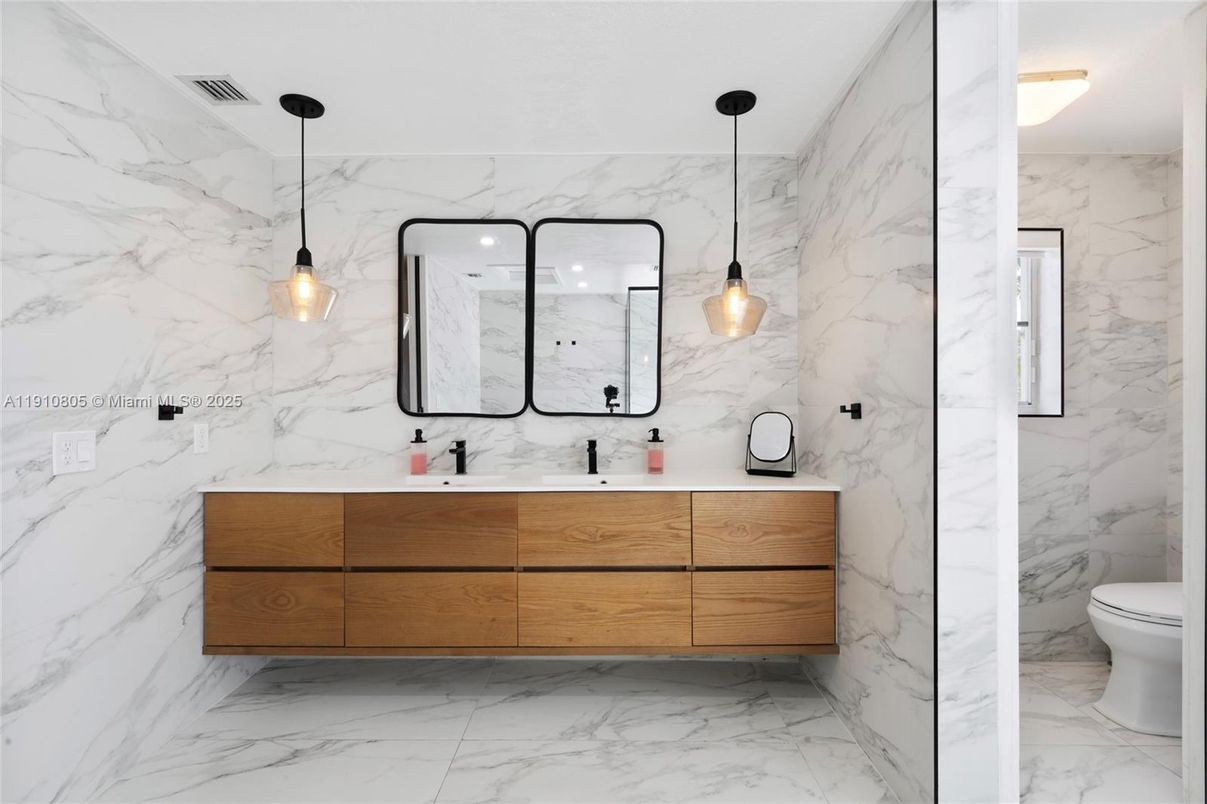 Bathroom, Dual Sink Vanities, Interior, Marble, Marble Walls, Pendant Lights, Recessed Lighting