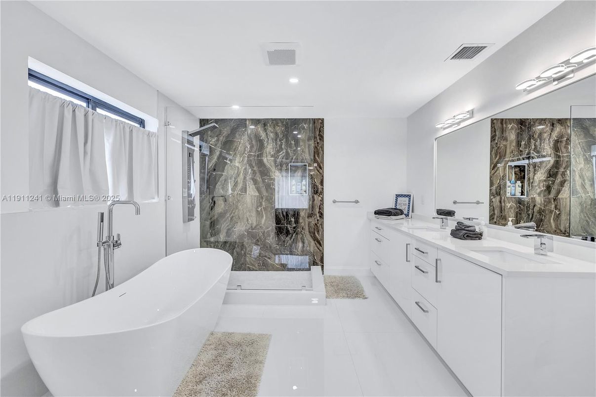 Bathroom, Dual Sink Vanities, Free Standing Baths, Glass Shower, Interior, Marble Walls, Recessed Lighting