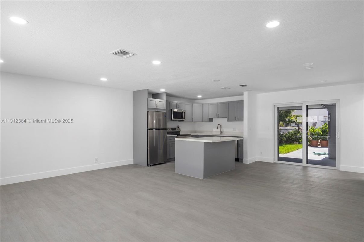 Empty room, Interior, Kitchen, Recessed Lighting, Stainless Steel Appliances, Wood Texture Flooring