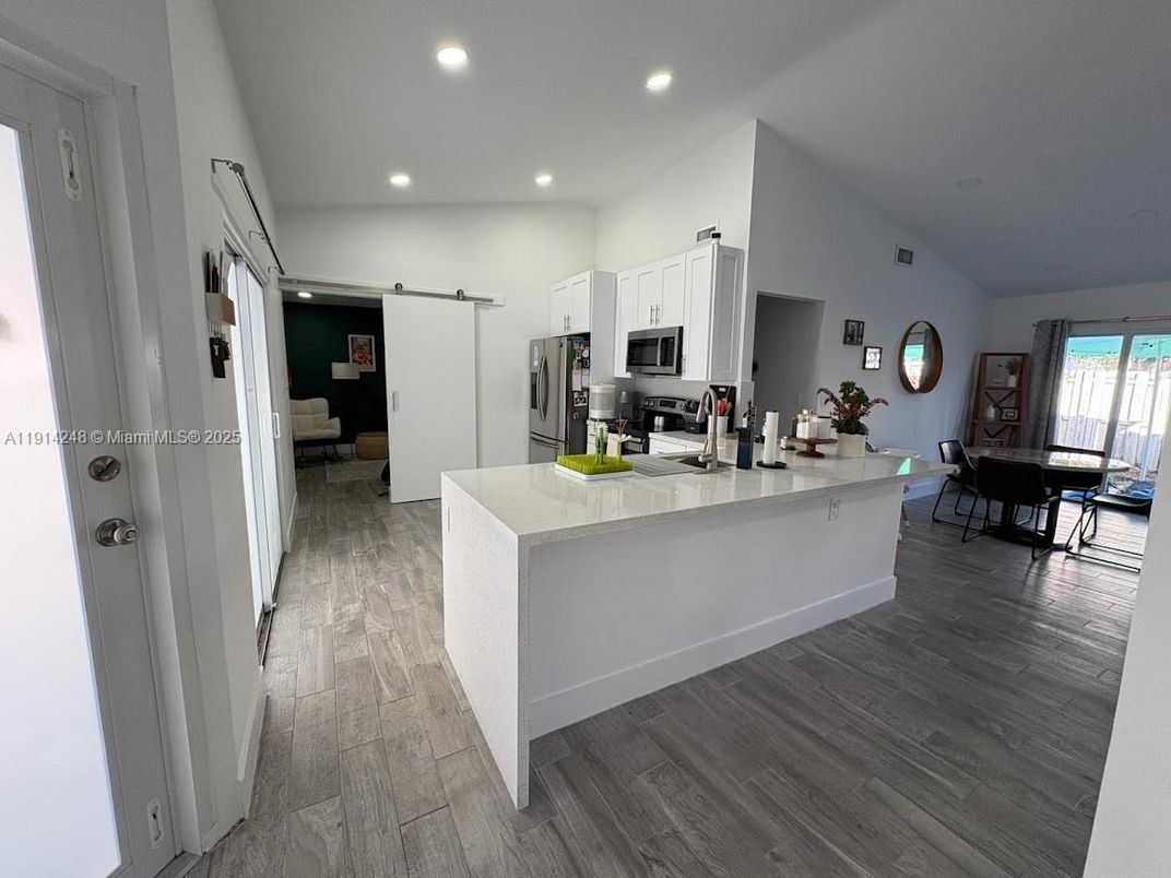Dining room, Interior, Kitchen, Recessed Lighting, Stainless Steel Appliances, Wood Texture Flooring