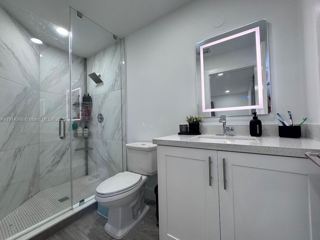 Bathroom, Glass Shower, Interior, Marble Walls, Recessed Lighting, Wood Texture Flooring