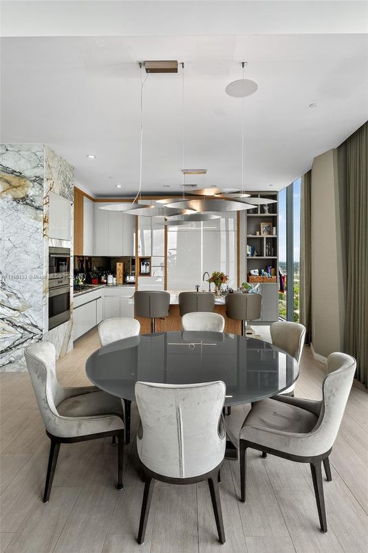 Dining room, Interior, Kitchen, Living room, Marble Walls, Pendant Lights, Recessed Lighting, Stainless Steel Appliances, Wood Texture Flooring