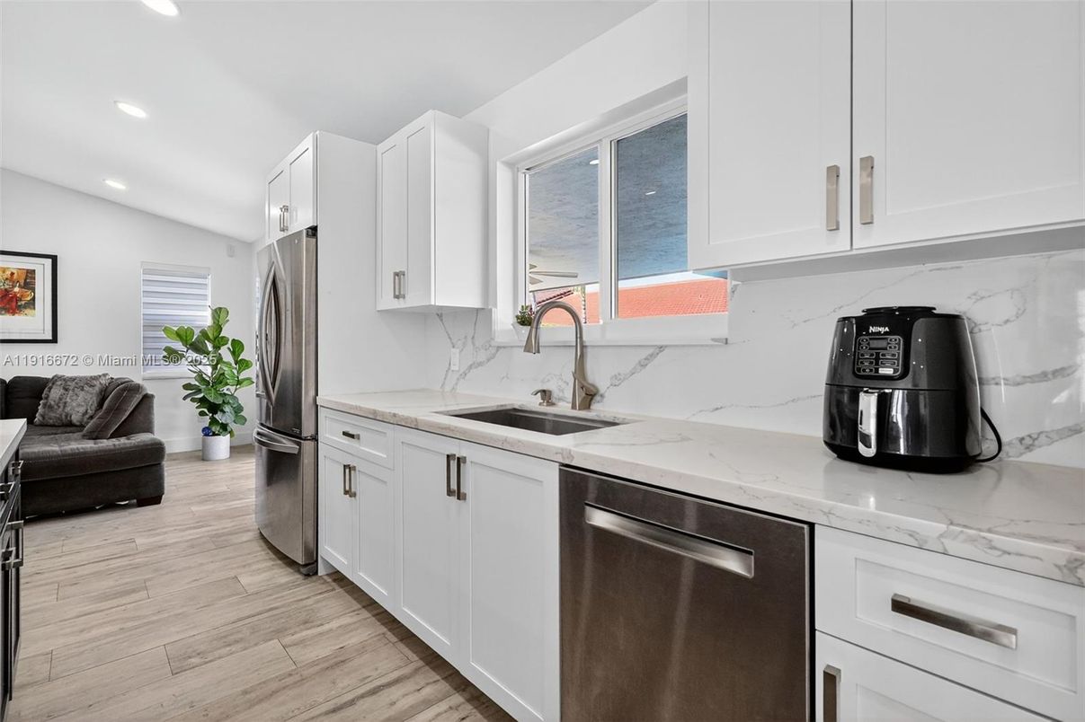 Interior, Kitchen, Marble Walls, Recessed Lighting, Stainless Steel Appliances, Wood Texture Flooring