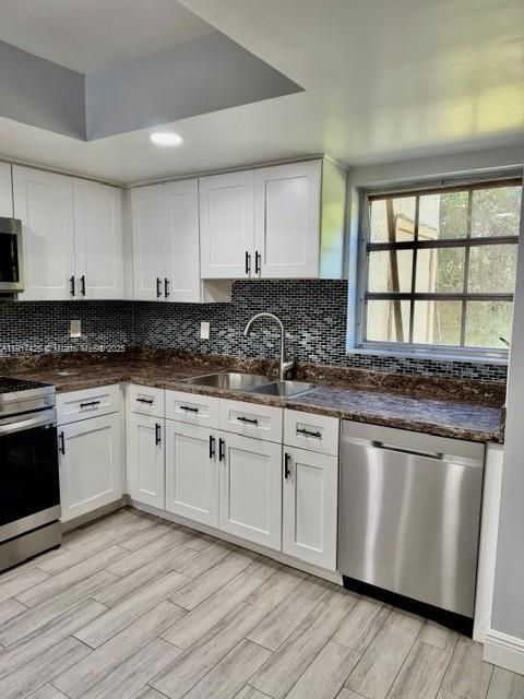 Empty room, Interior, Kitchen, Recessed Lighting, Stainless Steel Appliances, Wood Texture Flooring