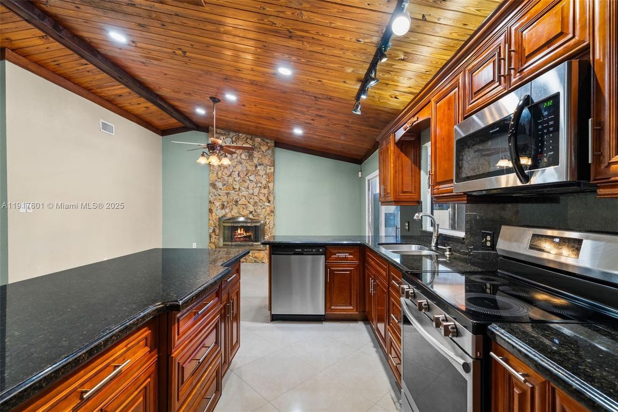 Fireplace, Interior, Kitchen, Recessed Lighting, Stainless Steel Appliances, Stone Walls, Wooden Beams, Wooden Ceilings