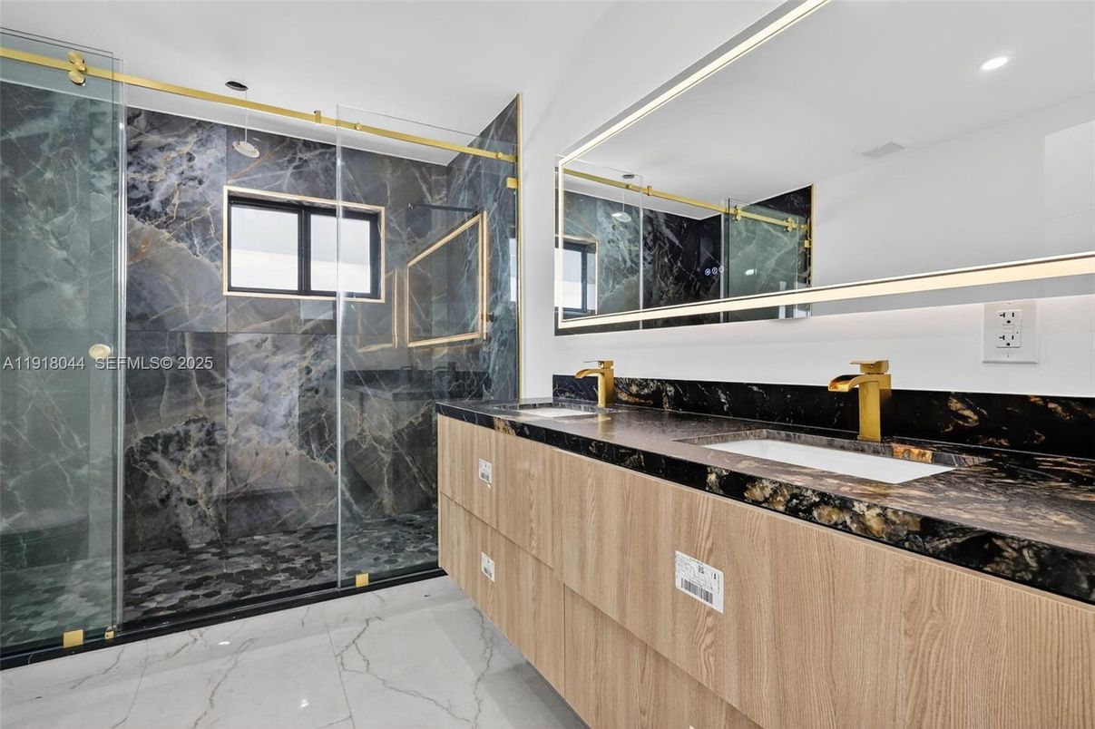 Bathroom, Dual Sink Vanities, Glass Shower, Interior, Marble, Marble Walls, Recessed Lighting