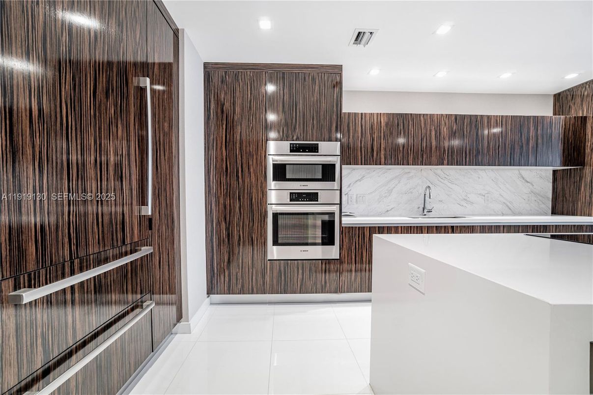 Interior, Kitchen, Marble Walls, Recessed Lighting, Stainless Steel Appliances