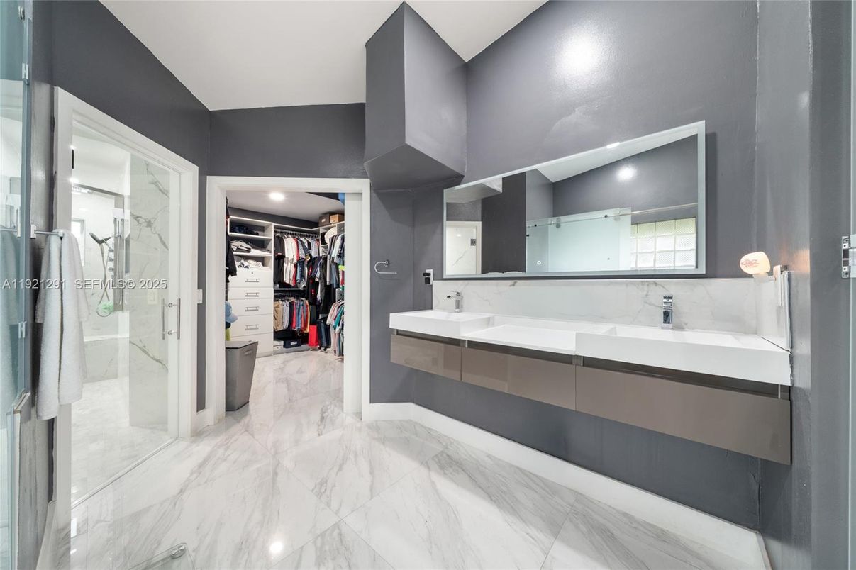 Bathroom, Dual Sink Vanities, Glass Shower, Interior, Marble, Marble Walls, Recessed Lighting, Walk-in Closets