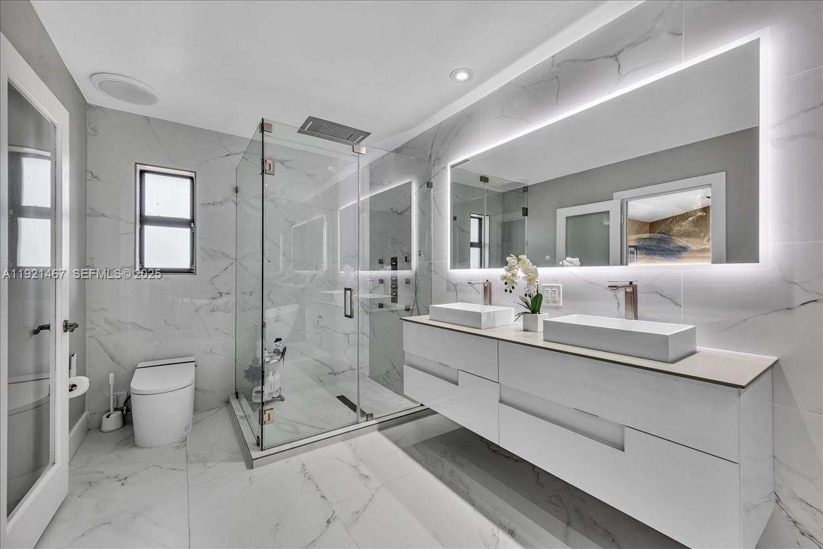 Bathroom, Dual Sink Vanities, Glass Shower, Interior, Marble, Marble Walls, Recessed Lighting
