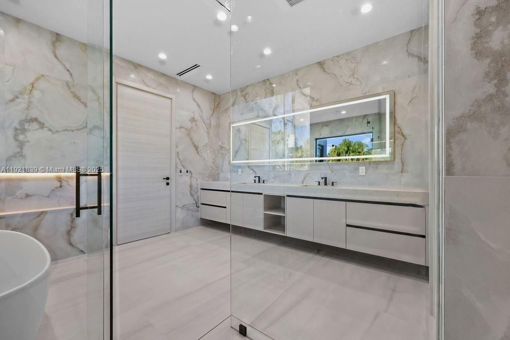 Bathroom, Dual Sink Vanities, Free Standing Baths, Glass Shower, Interior, Marble Walls, Recessed Lighting