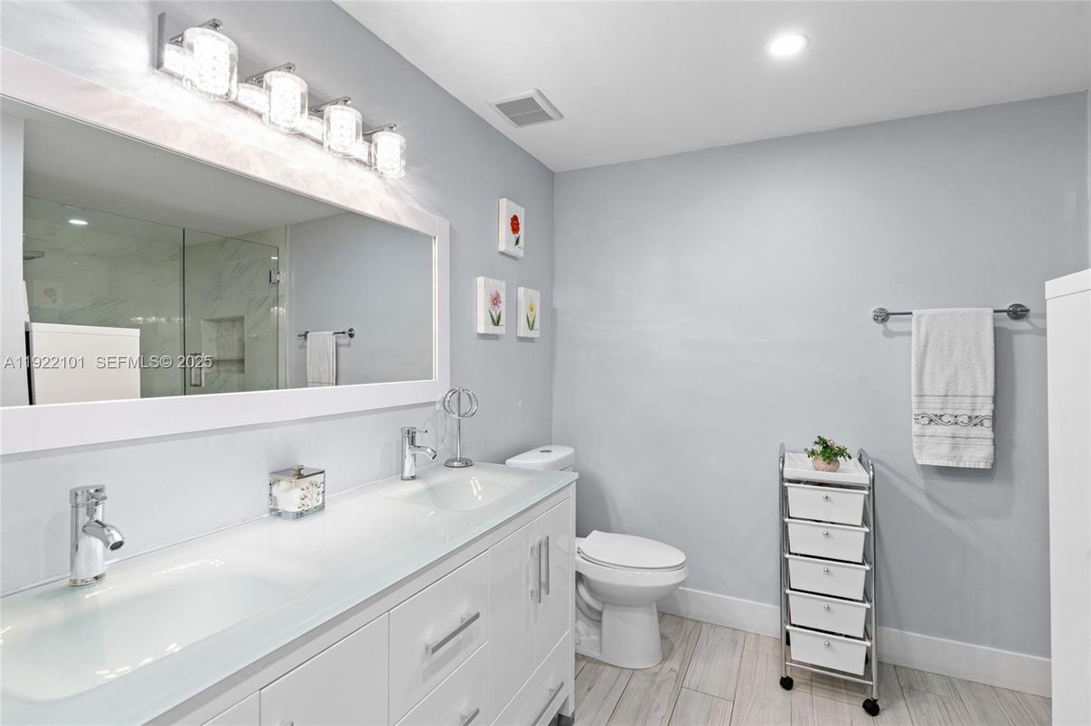 Bathroom, Dual Sink Vanities, Glass Shower, Interior, Recessed Lighting, Wood Texture Flooring