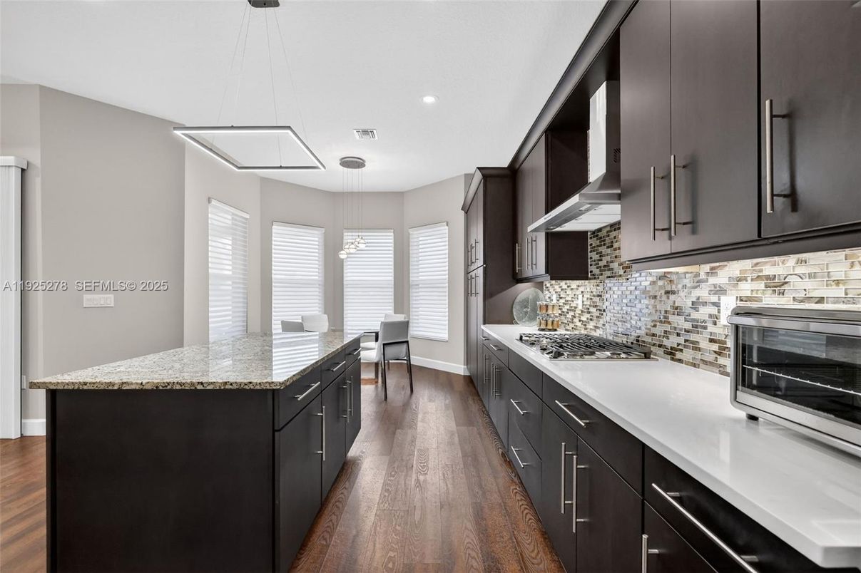 Dining room, Interior, Kitchen, Pendant Lights, Recessed Lighting, Stainless Steel Appliances, Wood Texture Flooring