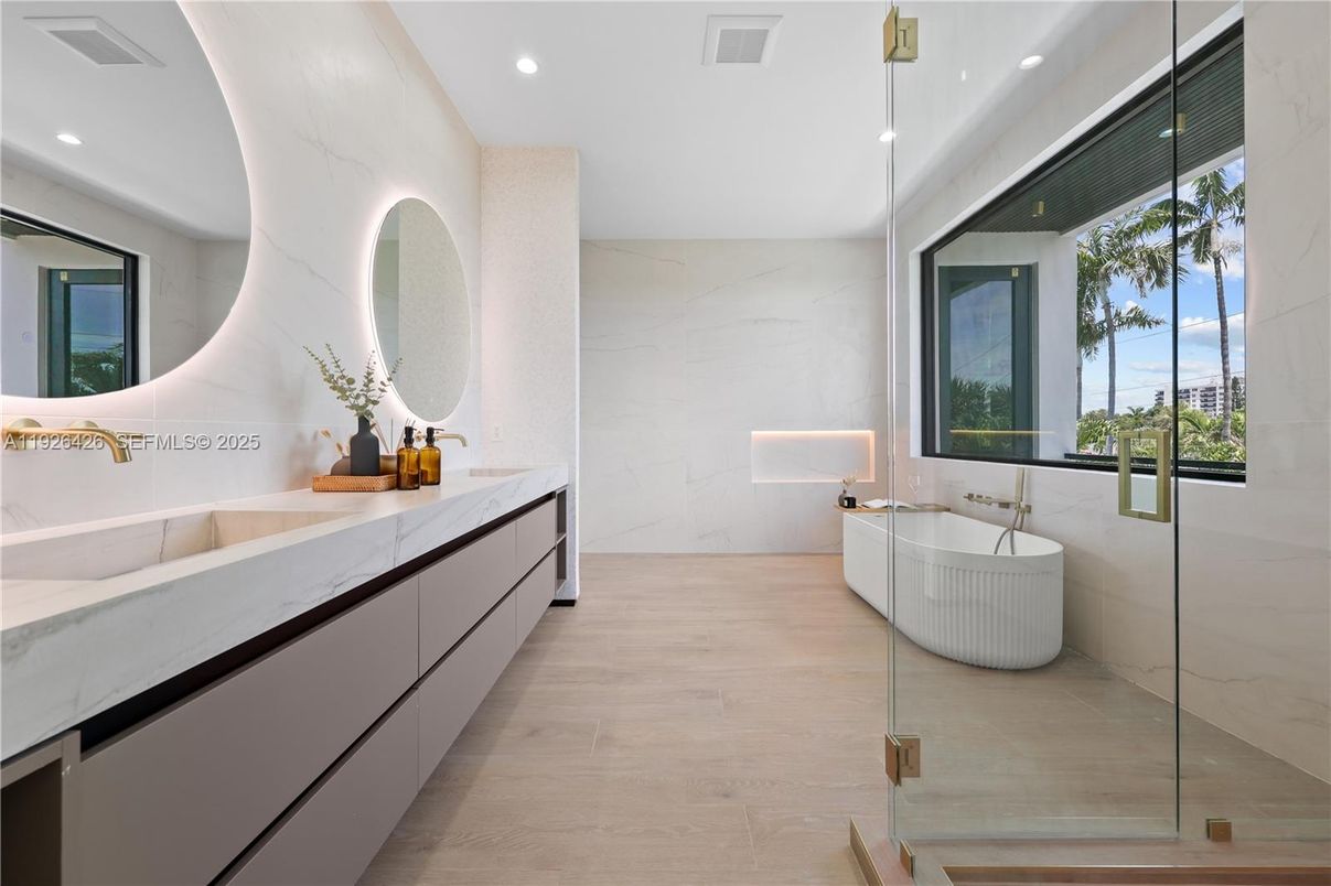 Bathroom, Dual Sink Vanities, Free Standing Baths, Glass Shower, Interior, Marble Walls, Recessed Lighting, Wood Texture Flooring
