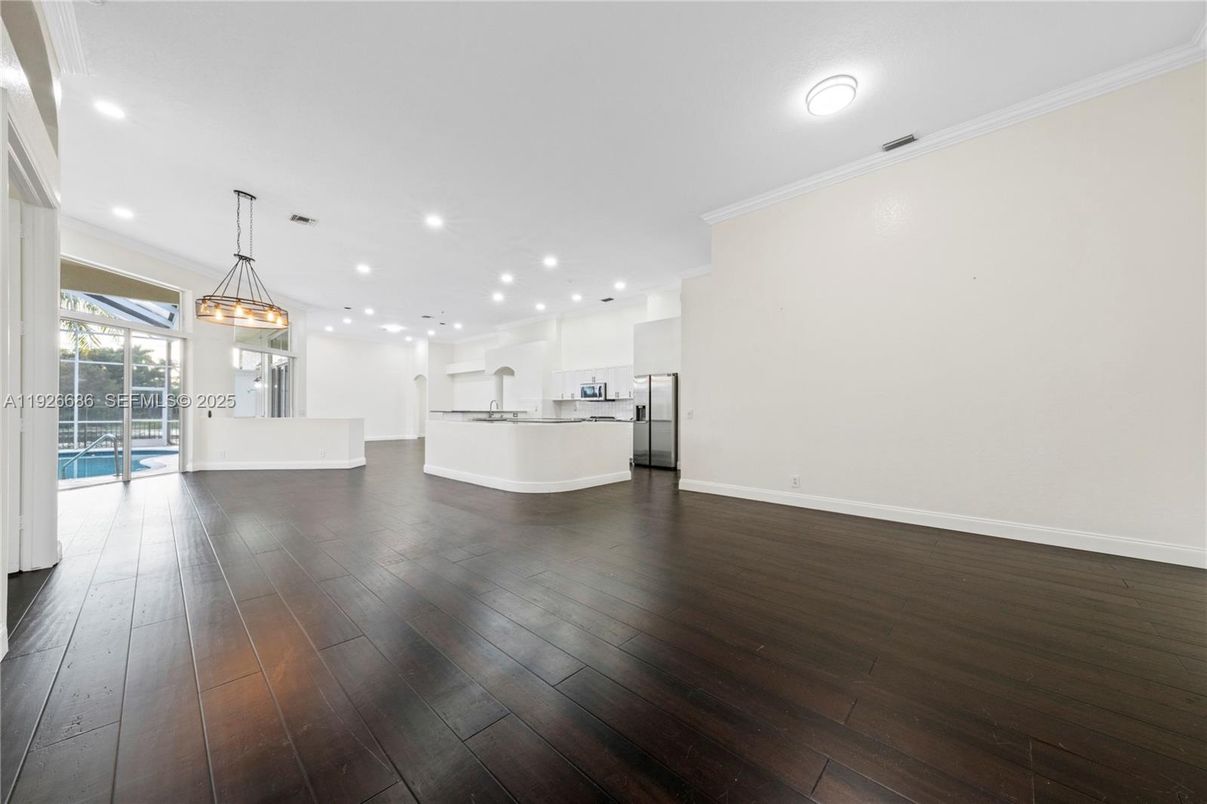Empty room, Interior, Kitchen, Pendant Lights, Recessed Lighting, Stainless Steel Appliances, Wood Texture Flooring