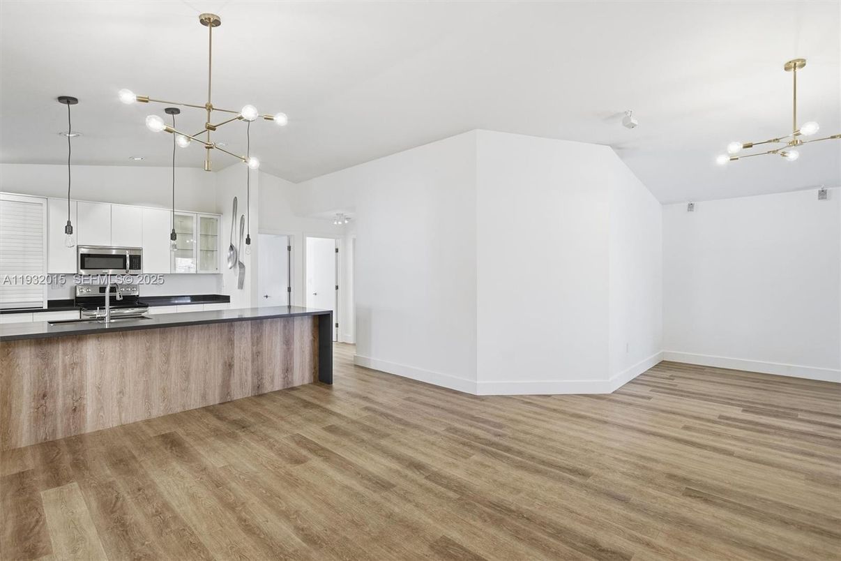 Empty room, Interior, Kitchen, Pendant Lights, Stainless Steel Appliances, Wood Texture Flooring