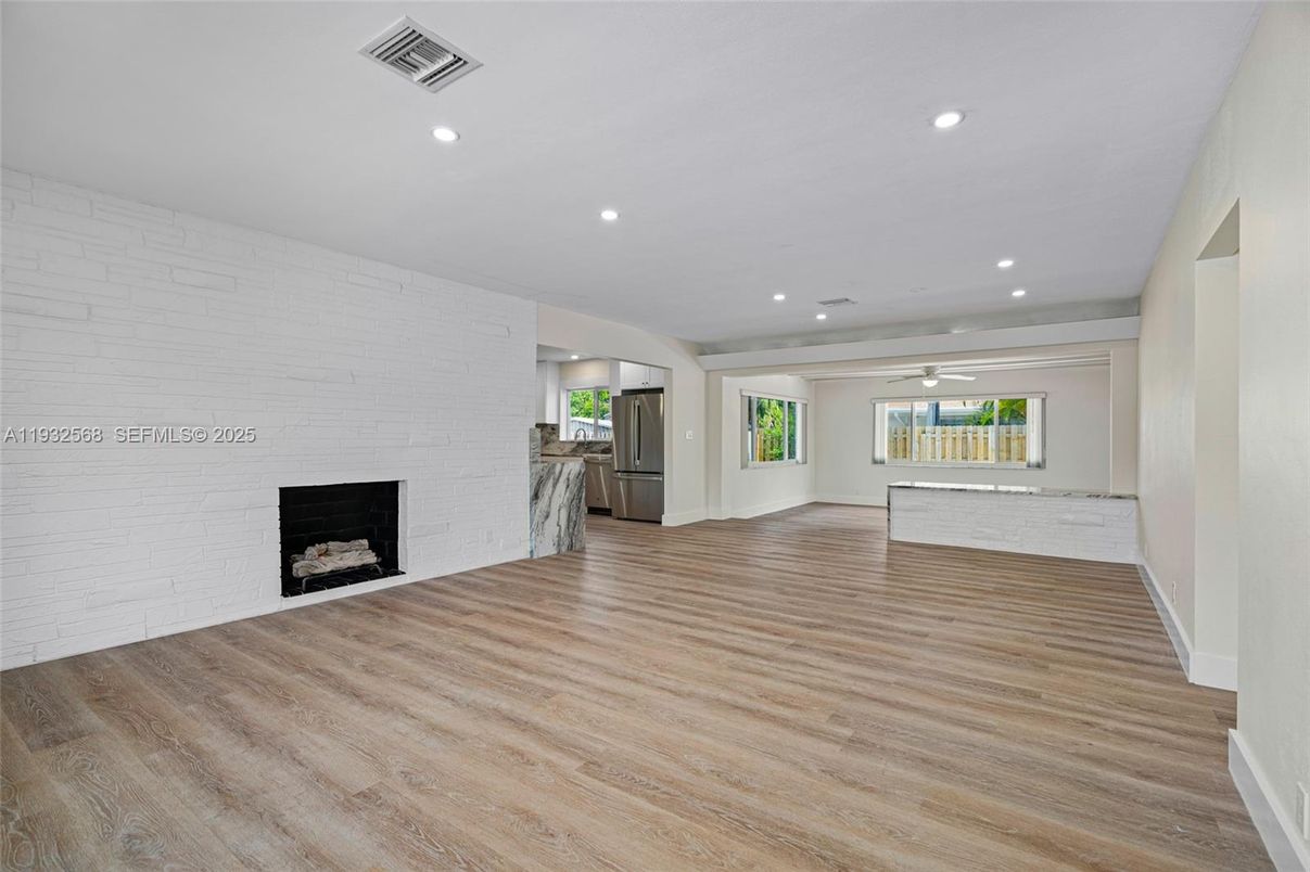 Empty room, Fireplace, Interior, Recessed Lighting, Stone Walls, Wood Texture Flooring