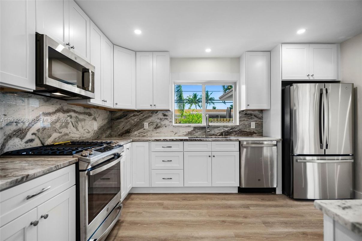 Interior, Kitchen, Marble Walls, Recessed Lighting, Stainless Steel Appliances, Wood Texture Flooring