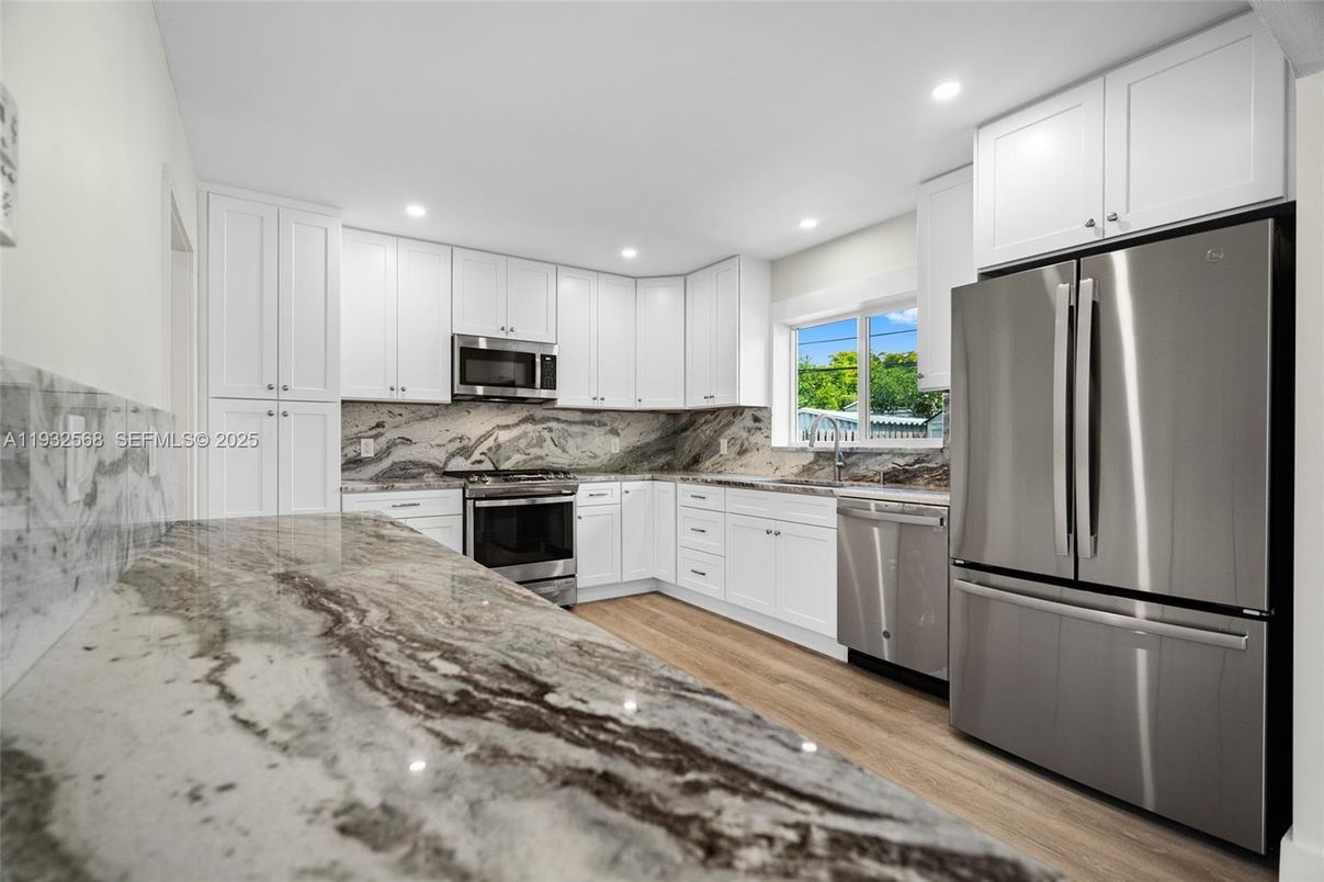 Interior, Kitchen, Marble Walls, Recessed Lighting, Stainless Steel Appliances, Wood Texture Flooring