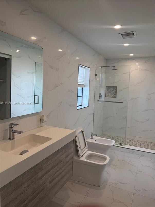 Bathroom, Dual Sink Vanities, Glass Shower, Interior, Marble, Marble Walls, Recessed Lighting