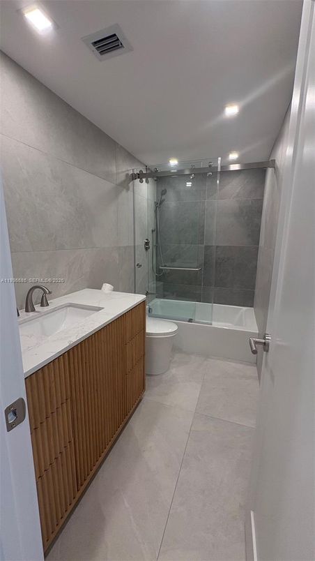 Bathroom, Dual Sink Vanities, Glass Shower, Interior, Marble Walls, Recessed Lighting