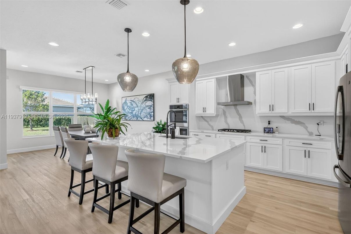 Chandelier, Dining room, Interior, Kitchen, Pendant Lights, Recessed Lighting, Stainless Steel Appliances, Wood Texture Flooring