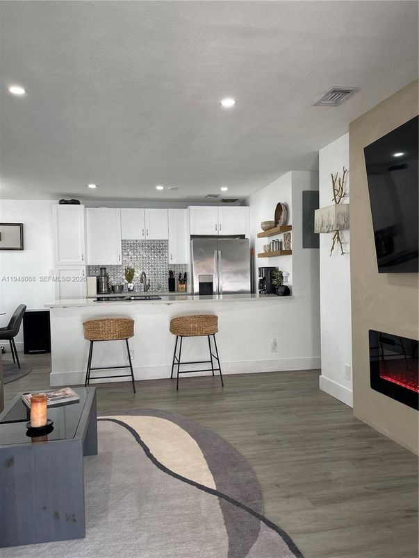 Fireplace, Interior, Kitchen, Recessed Lighting, Stainless Steel Appliances, Wood Texture Flooring