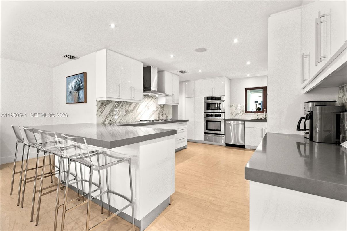 Interior, Kitchen, Marble Walls, Recessed Lighting, Stainless Steel Appliances, Wood Texture Flooring