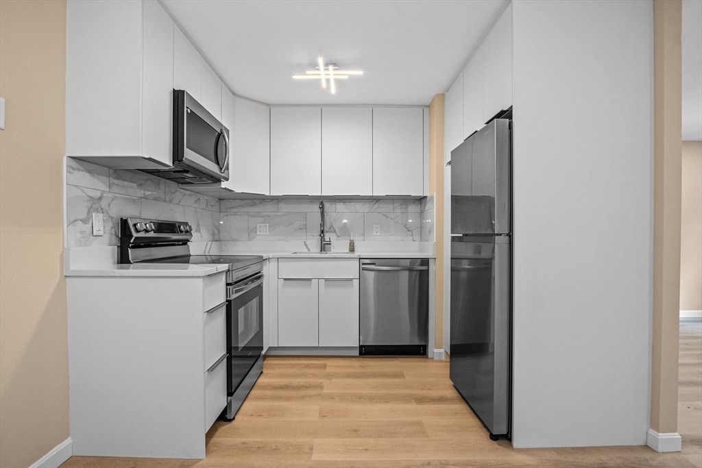 Interior, Kitchen, Marble Walls, Stainless Steel Appliances, Wood Texture Flooring