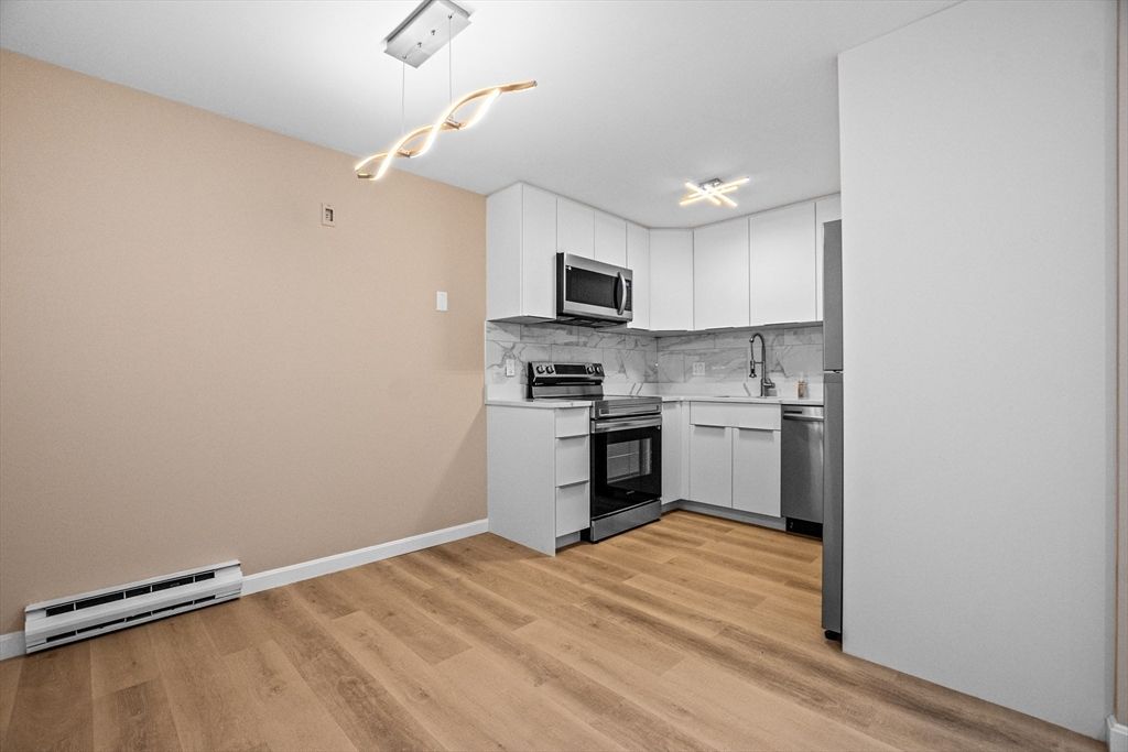 Interior, Kitchen, Marble Walls, Pendant Lights, Stainless Steel Appliances, Wood Texture Flooring
