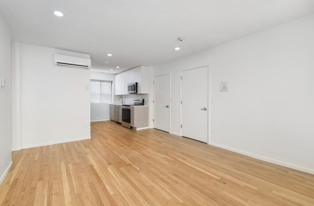 Empty room, Interior, Kitchen, Recessed Lighting, Stainless Steel Appliances, Wood Texture Flooring