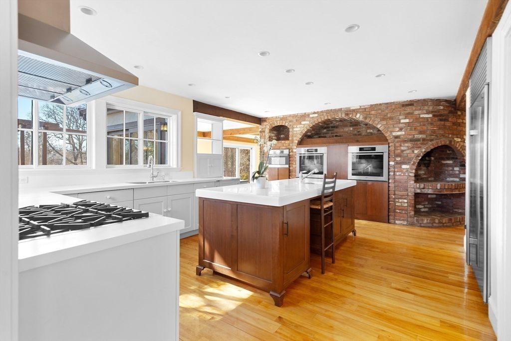 Fireplace, Interior, Kitchen, Recessed Lighting, Stainless Steel Appliances, Stone Walls, Wood Texture Flooring