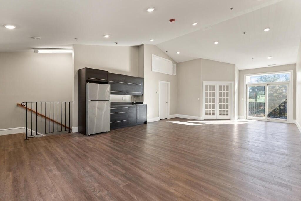 Empty room, Interior, Kitchen, Recessed Lighting, Stainless Steel Appliances, Wood Texture Flooring