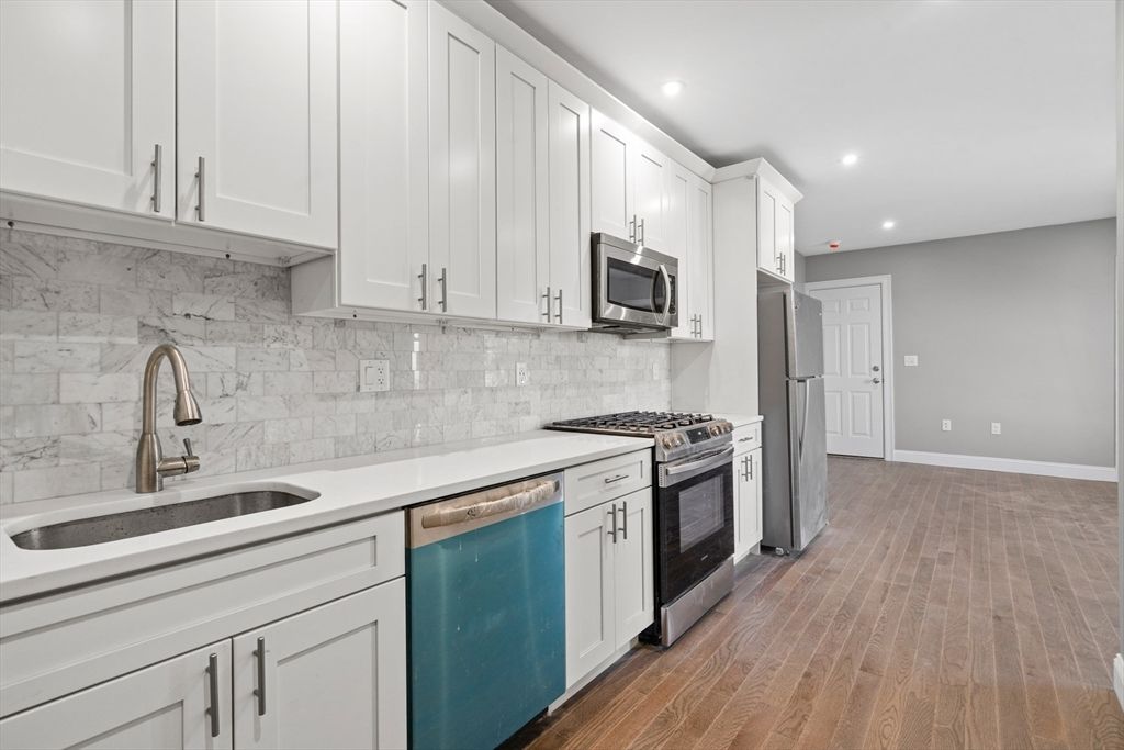 Interior, Kitchen, Marble Walls, Recessed Lighting, Stainless Steel Appliances, Wood Texture Flooring