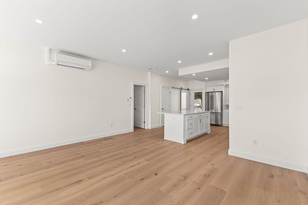 Empty room, Interior, Kitchen, Recessed Lighting, Stainless Steel Appliances, Wood Texture Flooring