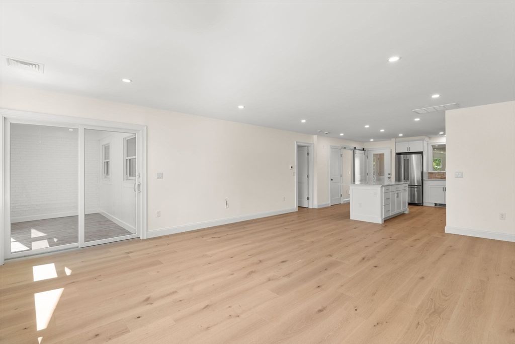 Empty room, Interior, Kitchen, Recessed Lighting, Stainless Steel Appliances, Wood Texture Flooring